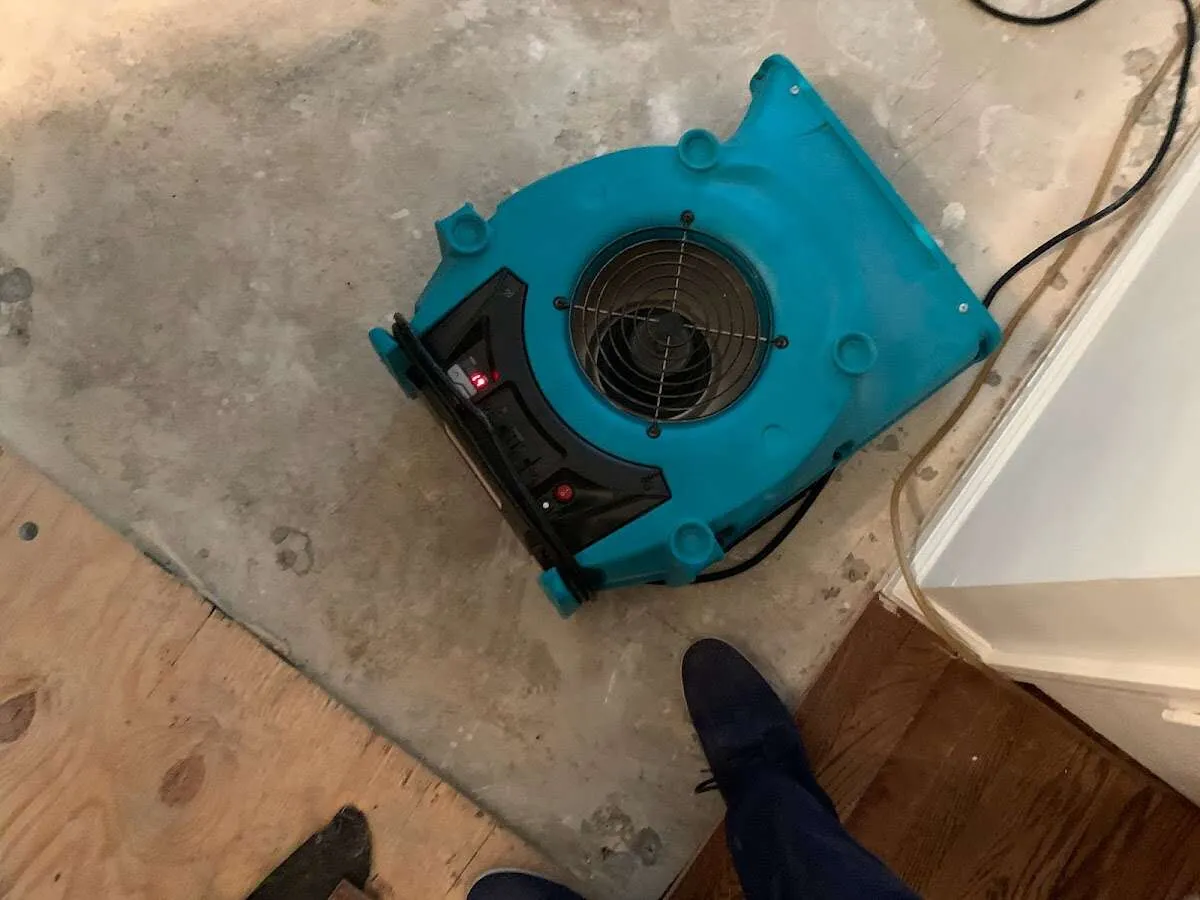 Air mover drying subfloor during Commercial Water Damage Restoration in Godfrey